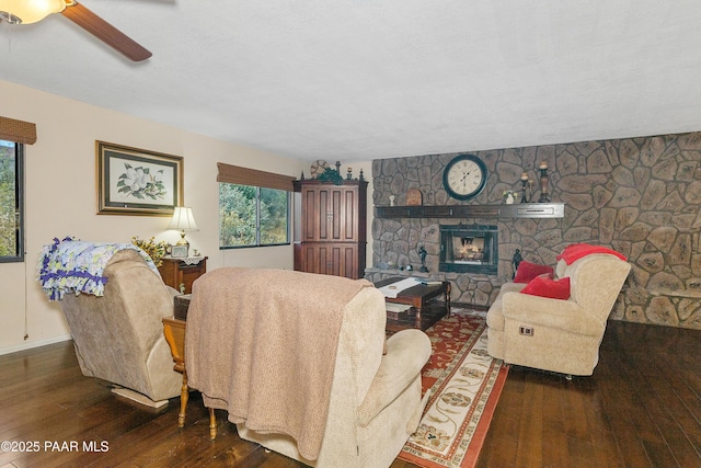 1116 Christie Ln, Prescott, AZ 86305 - living area with baseboards, a stone fireplace, a ceiling fan, and wood finished floors