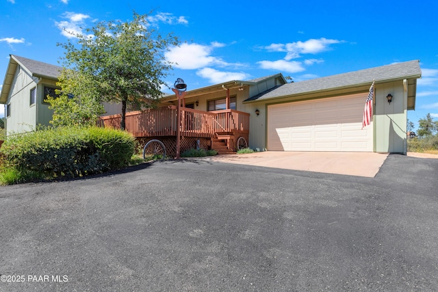 1116 Christie Ln, Prescott, AZ 86305 - view of front of home featuring an attached garage, driveway, and a wooden deck