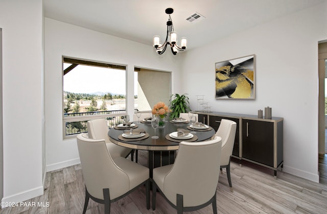 12290 N Thrine Cir, Prescott, AZ 86305 - dining area with baseboards, light wood-style floors, a chandelier, and visible vents