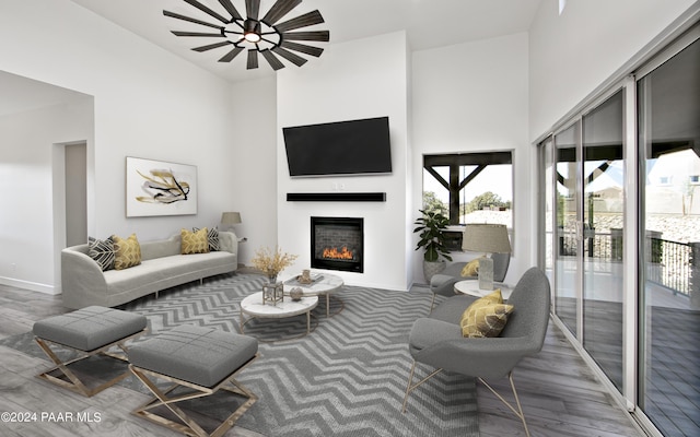 12290 N Thrine Cir, Prescott, AZ 86305 - living area with a high ceiling, a glass covered fireplace, and wood finished floors