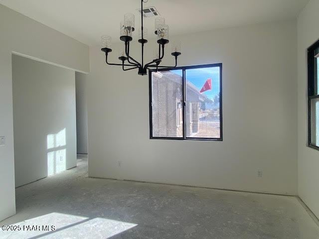 empty room featuring visible vents and a notable chandelier