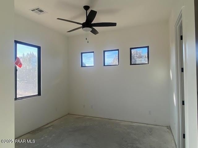 unfurnished room with a ceiling fan and visible vents