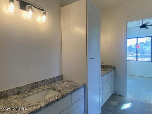 bathroom featuring ceiling fan and vanity