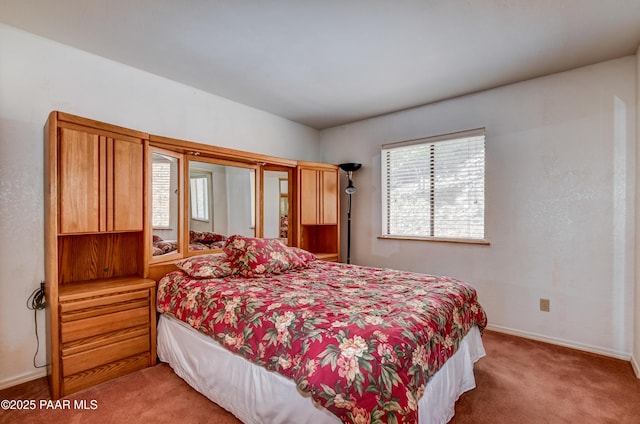 bedroom with baseboards and carpet flooring