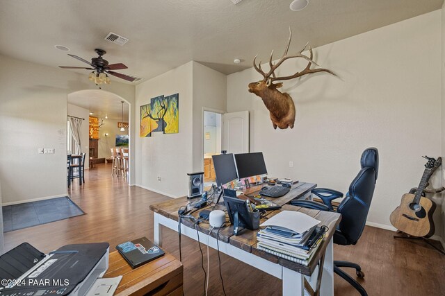 office with wood-type flooring and ceiling fan