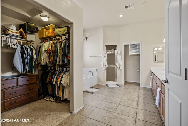 bathroom with tile patterned flooring, vanity, and separate shower and tub