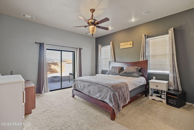 carpeted bedroom with ceiling fan and access to outside