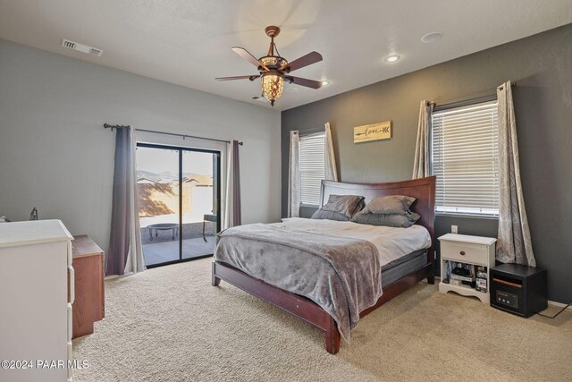 carpeted bedroom with ceiling fan and access to outside