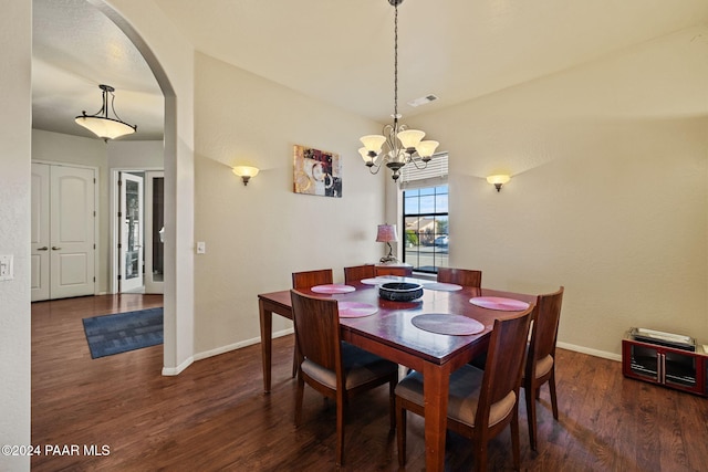 dining space featuring a notable chandelier, dark hardwood / wood-style floors, and vaulted ceiling