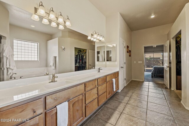 bathroom with vanity and a bath