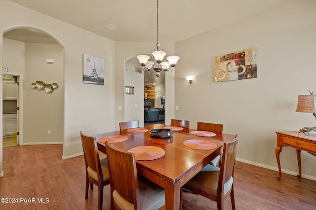 dining room featuring an inviting chandelier and light hardwood / wood-style flooring