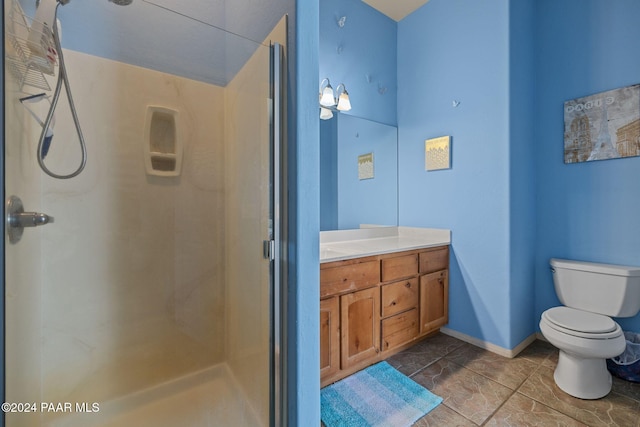 bathroom with tile patterned floors, vanity, toilet, and walk in shower