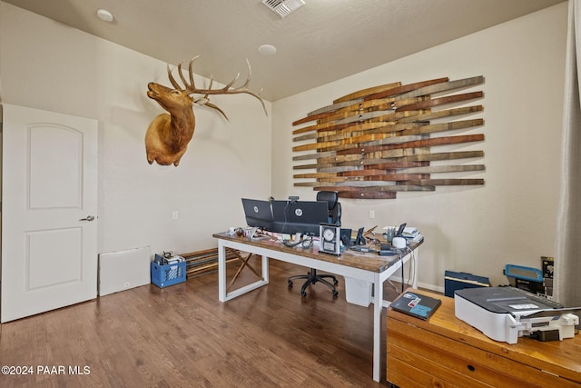 office with wood-type flooring and a textured ceiling