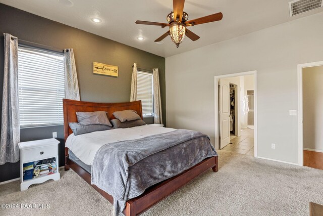 carpeted bedroom with ceiling fan and ensuite bathroom