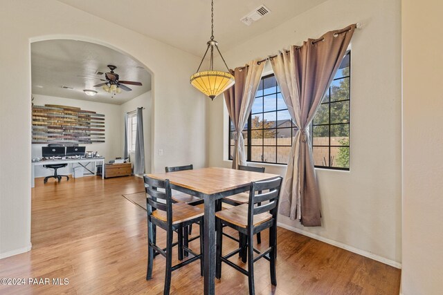 dining area featuring ceiling fan and wood-type flooring