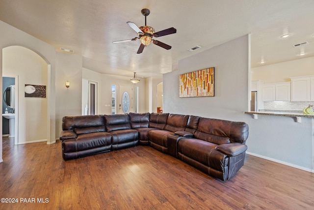 living room featuring ceiling fan and hardwood / wood-style floors