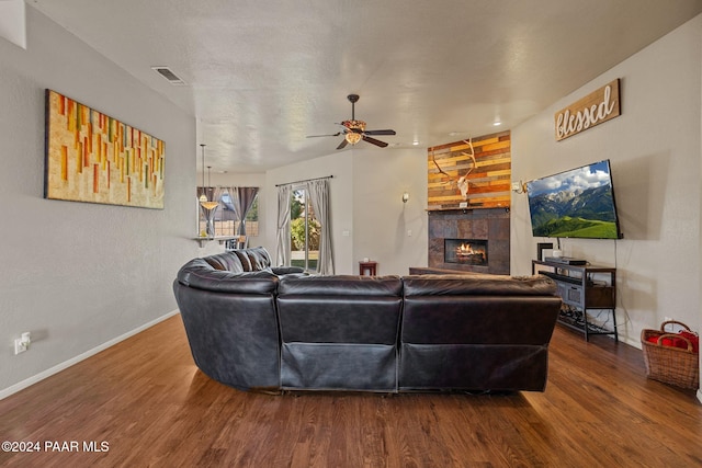 living room with a fireplace, hardwood / wood-style flooring, and ceiling fan