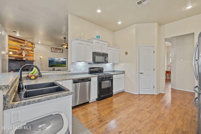 kitchen featuring ceiling fan, sink, light hardwood / wood-style floors, white cabinets, and appliances with stainless steel finishes