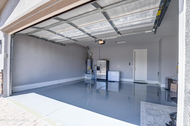 garage featuring water heater, baseboards, a garage door opener, and stainless steel fridge with ice dispenser