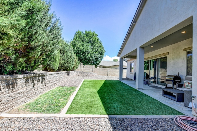 view of yard with a fenced backyard and a patio area