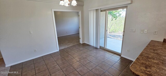 10919 E Roundup Dr, Dewey-Humboldt, AZ 86327 - unfurnished dining area with a chandelier, dark tile patterned flooring, and dark carpet