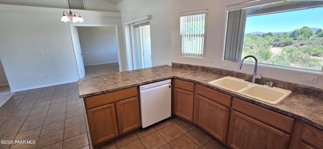 10919 E Roundup Dr, Dewey-Humboldt, AZ 86327 - kitchen with white dishwasher, tile patterned floors, dark countertops, and vaulted ceiling