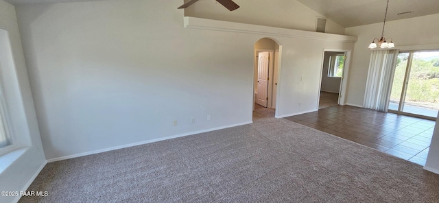 10919 E Roundup Dr, Dewey-Humboldt, AZ 86327 - spare room featuring a ceiling fan, arched walkways, dark tile patterned floors, a chandelier, and dark colored carpet