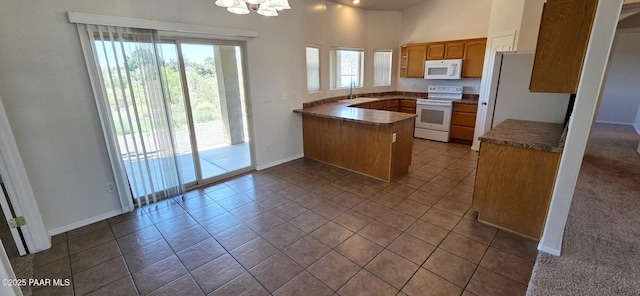 10919 E Roundup Dr, Dewey-Humboldt, AZ 86327 - kitchen featuring white appliances, a peninsula, tile patterned floors, a chandelier, and brown cabinets