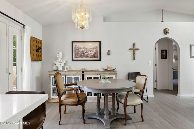 5420 N Mesquite Dr, Prescott Valley, AZ 86314 - dining space featuring arched walkways, light wood-style floors, baseboards, a chandelier, and vaulted ceiling