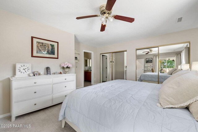 5420 N Mesquite Dr, Prescott Valley, AZ 86314 - bedroom featuring two closets, light colored carpet, ceiling fan, and ensuite bath