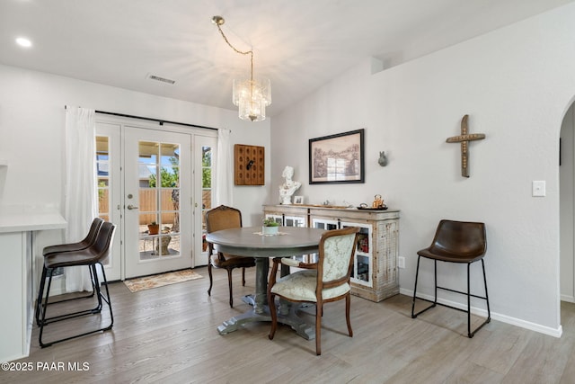 5420 N Mesquite Dr, Prescott Valley, AZ 86314 - dining room featuring light wood-type flooring, a chandelier, arched walkways, baseboards, and recessed lighting