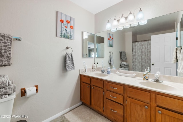 5420 N Mesquite Dr, Prescott Valley, AZ 86314 - bathroom featuring double vanity, toilet, and baseboards