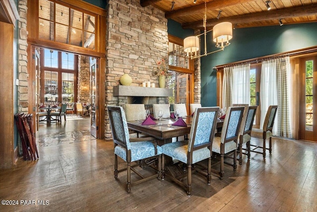 dining space with hardwood / wood-style floors, beamed ceiling, wooden ceiling, and an inviting chandelier