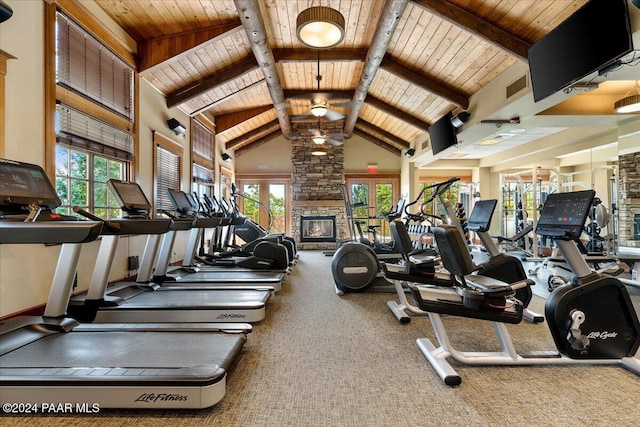 gym with carpet flooring, plenty of natural light, and high vaulted ceiling