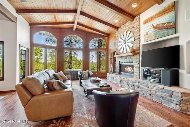 living room with hardwood / wood-style floors, a healthy amount of sunlight, wooden ceiling, and high vaulted ceiling