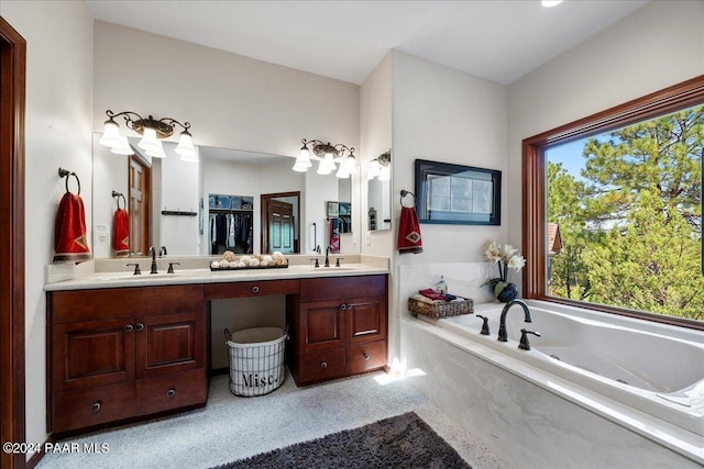 bathroom featuring vanity and tiled bath