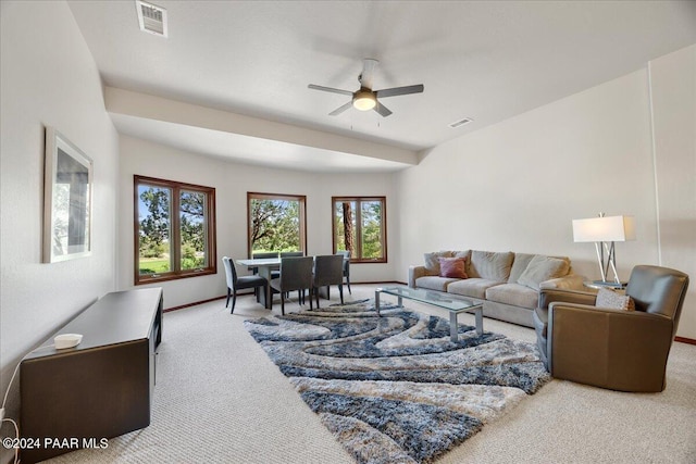 carpeted living room with ceiling fan