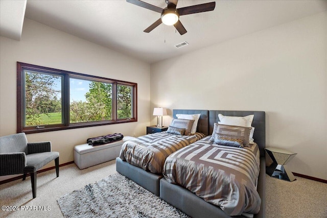 bedroom featuring light colored carpet and ceiling fan