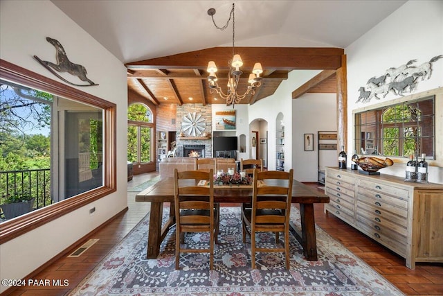 dining space featuring a stone fireplace, vaulted ceiling, a notable chandelier, dark hardwood / wood-style flooring, and wood ceiling