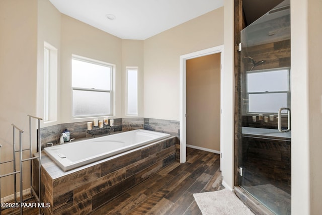 bathroom featuring hardwood / wood-style floors and separate shower and tub