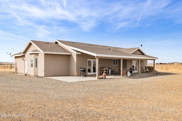 rear view of property featuring french doors and a patio