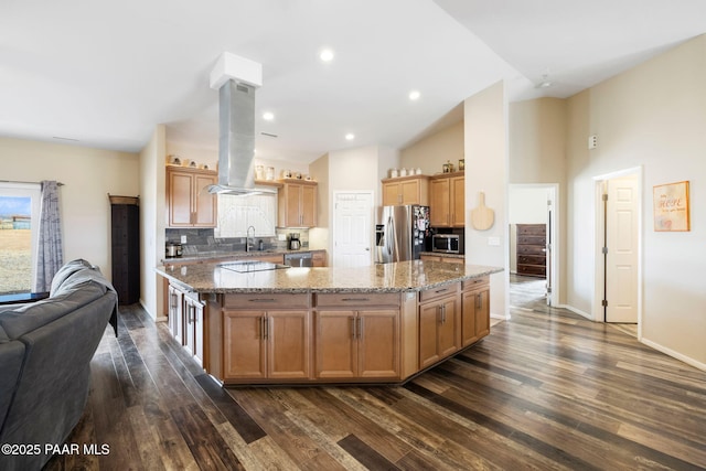 kitchen with island exhaust hood, a kitchen island, stainless steel appliances, and dark hardwood / wood-style floors