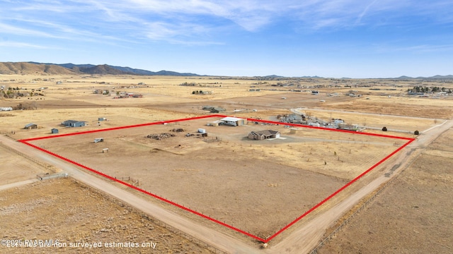 birds eye view of property with a mountain view and a rural view