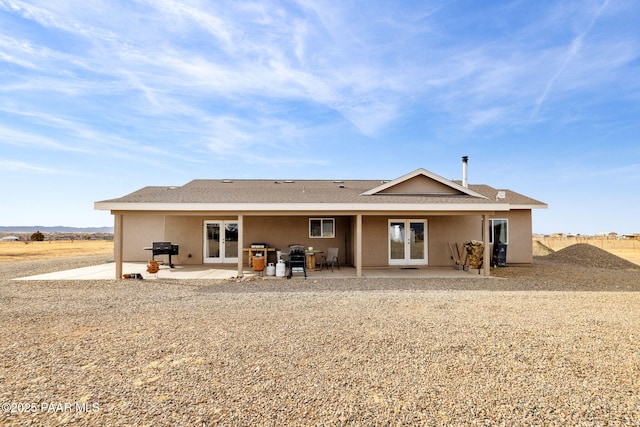 rear view of house with french doors and a patio