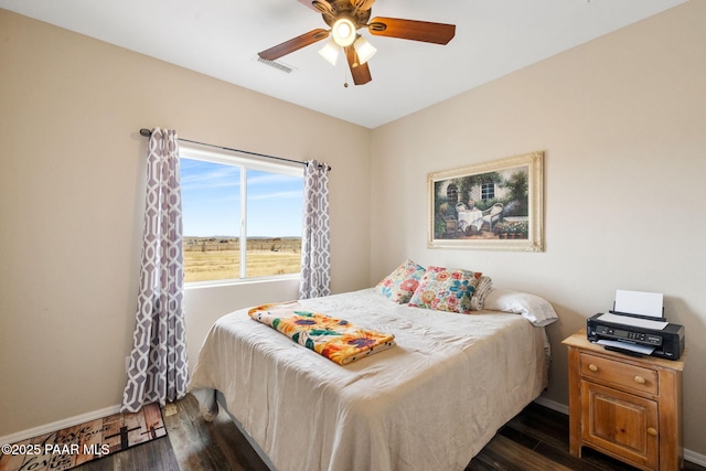 bedroom featuring dark hardwood / wood-style floors and ceiling fan