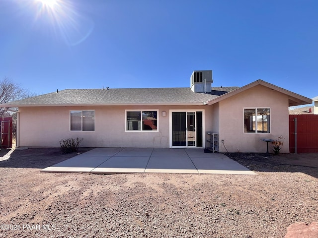 back of property with a patio area, fence, central AC unit, and stucco siding