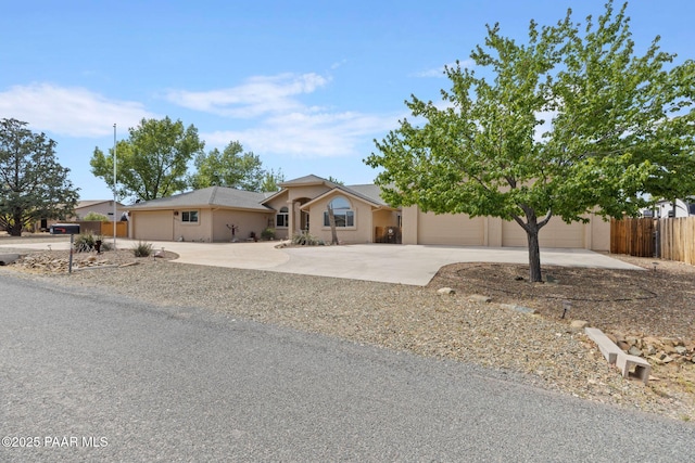 5278 N Saddleback Dr, Prescott Valley, AZ 86314 - ranch-style home with concrete driveway, stucco siding, fence, and a garage