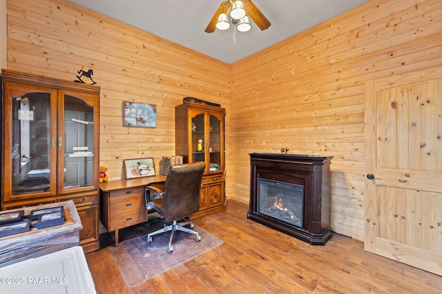 5278 N Saddleback Dr, Prescott Valley, AZ 86314 - office with wooden walls, a ceiling fan, and a glass covered fireplace