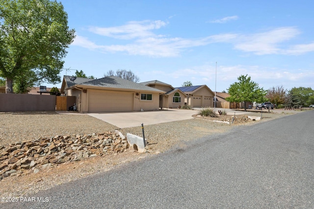 5278 N Saddleback Dr, Prescott Valley, AZ 86314 - ranch-style home featuring fence, an attached garage, stucco siding, solar panels, and driveway
