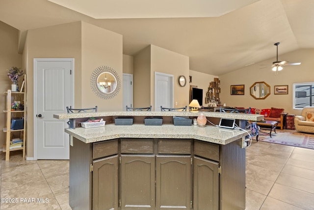 5278 N Saddleback Dr, Prescott Valley, AZ 86314 - kitchen featuring open floor plan, ceiling fan with notable chandelier, light tile patterned floors, and vaulted ceiling